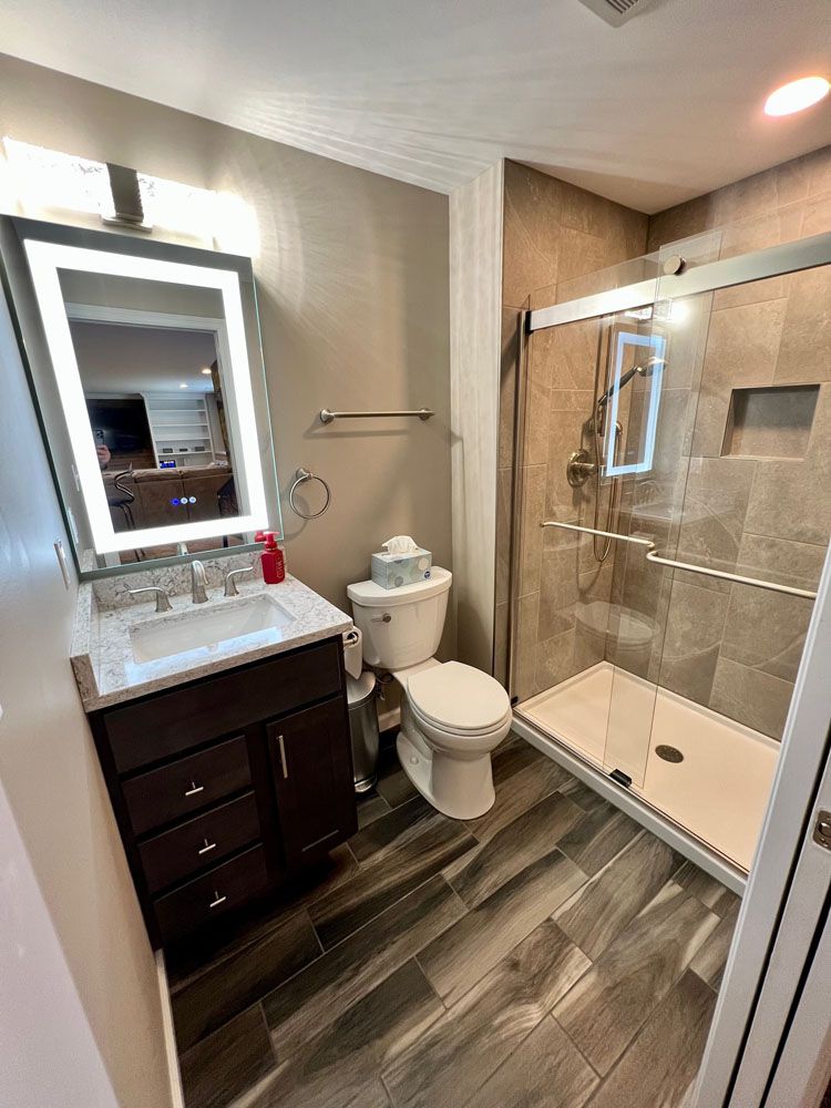 A bathroom with a led light mirror