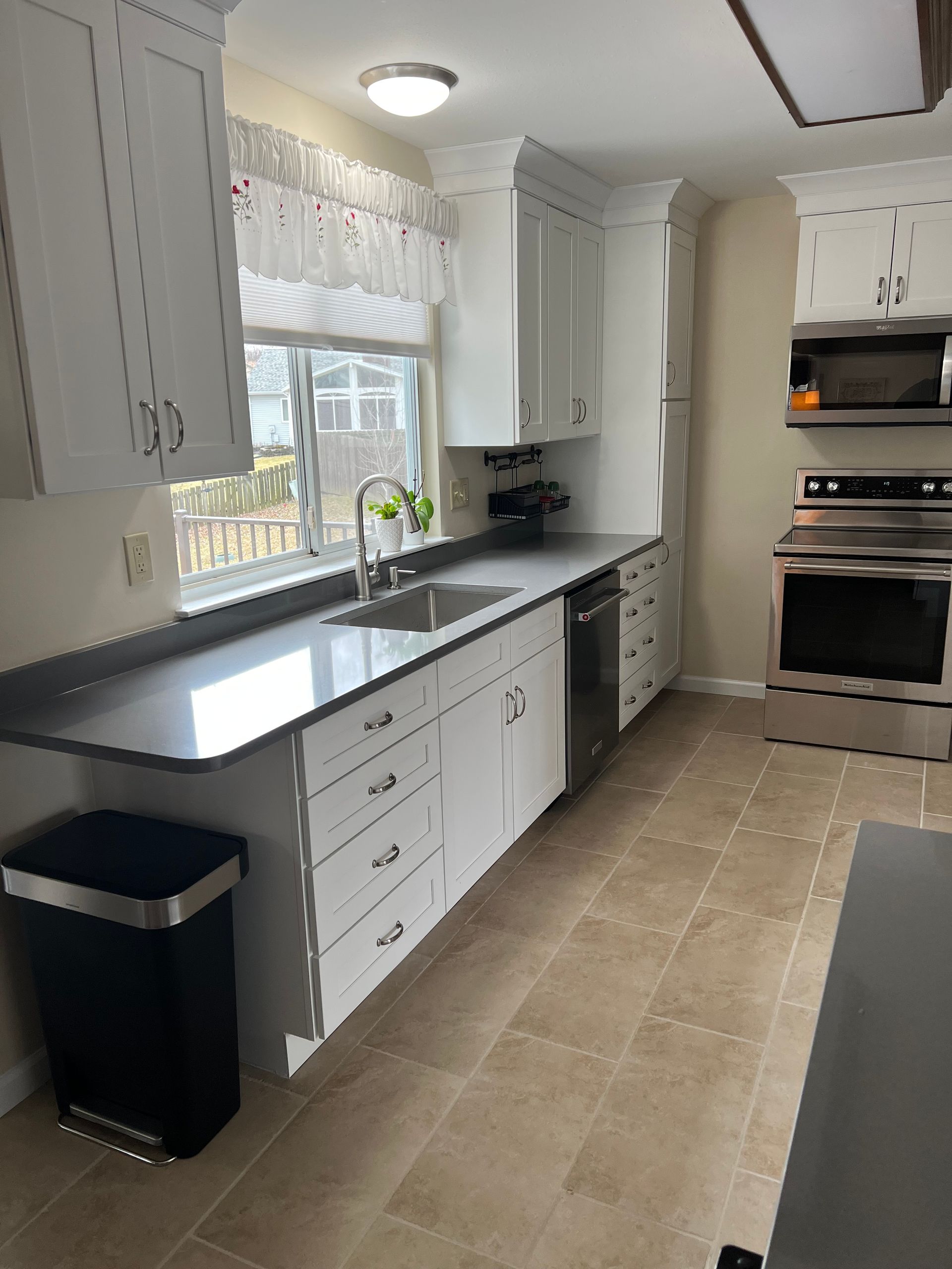 A kitchen with white cabinets and granite counter tops