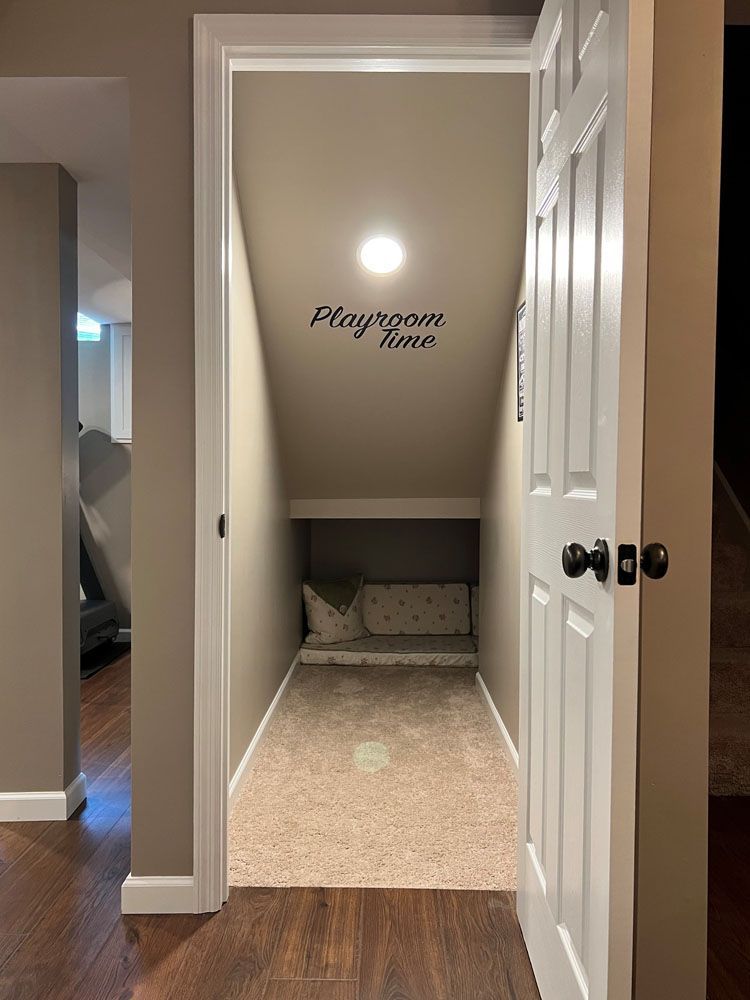 There is a playroom under the stairs in the basement