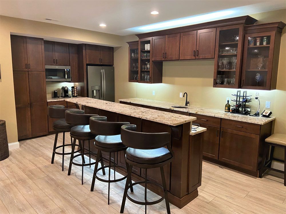 A kitchen with a bar and stools in it