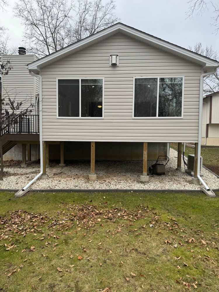 The back of a house with a lot of windows and a deck