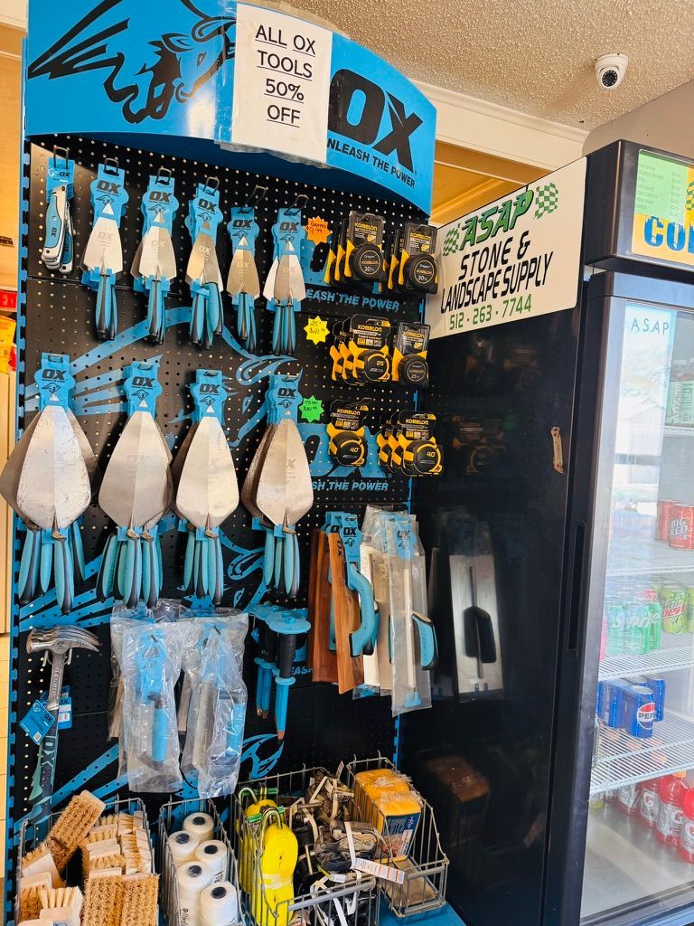 Display of blue-and-white pet leashes and accessories hanging in a shop kiosk