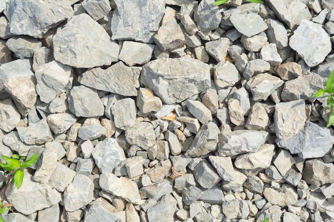 Pile of light gray rocks and gravel filling the frame.