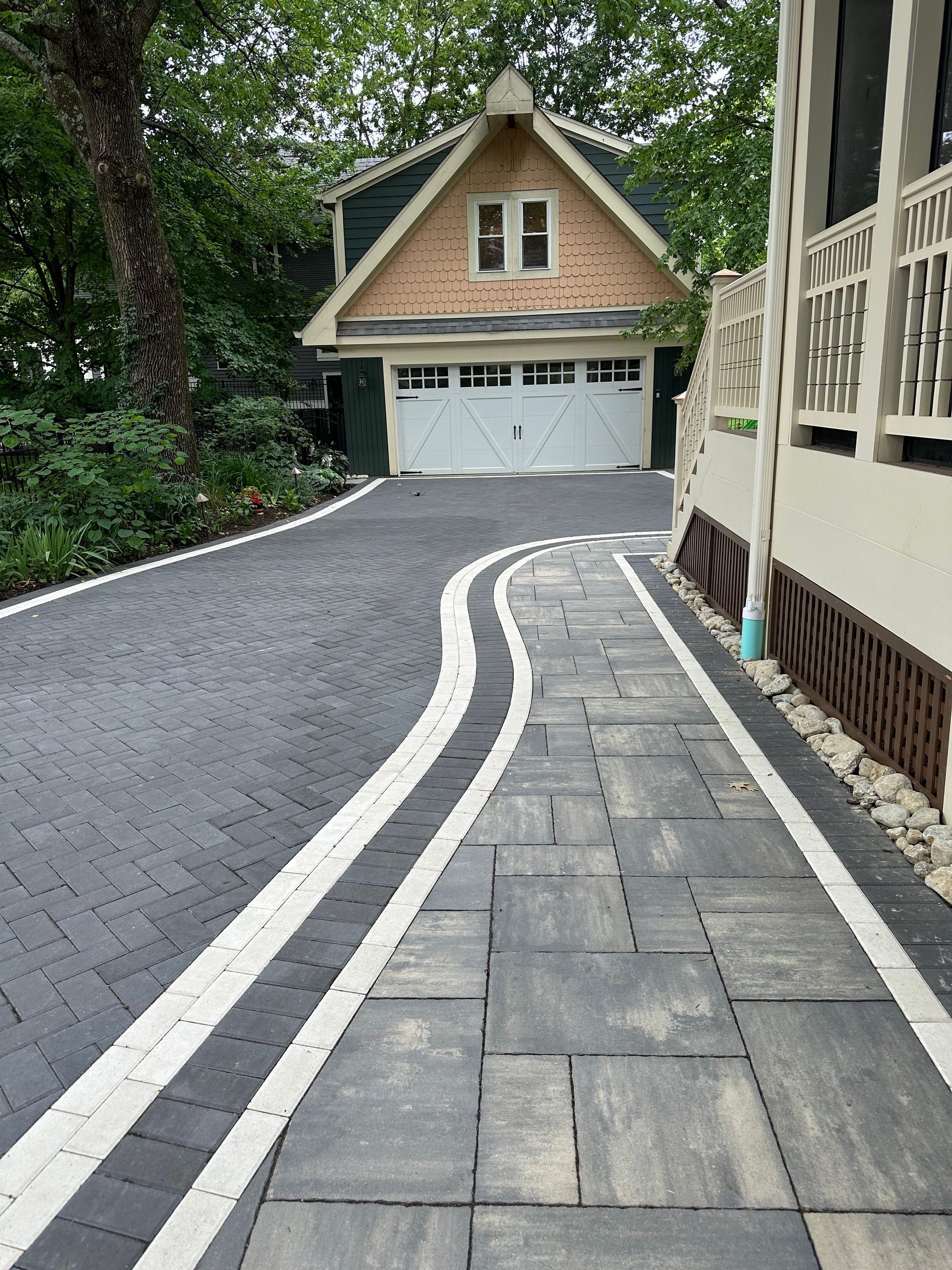 A driveway leading to a house with a garage door