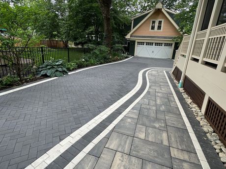 A driveway leading to a house with a garage.