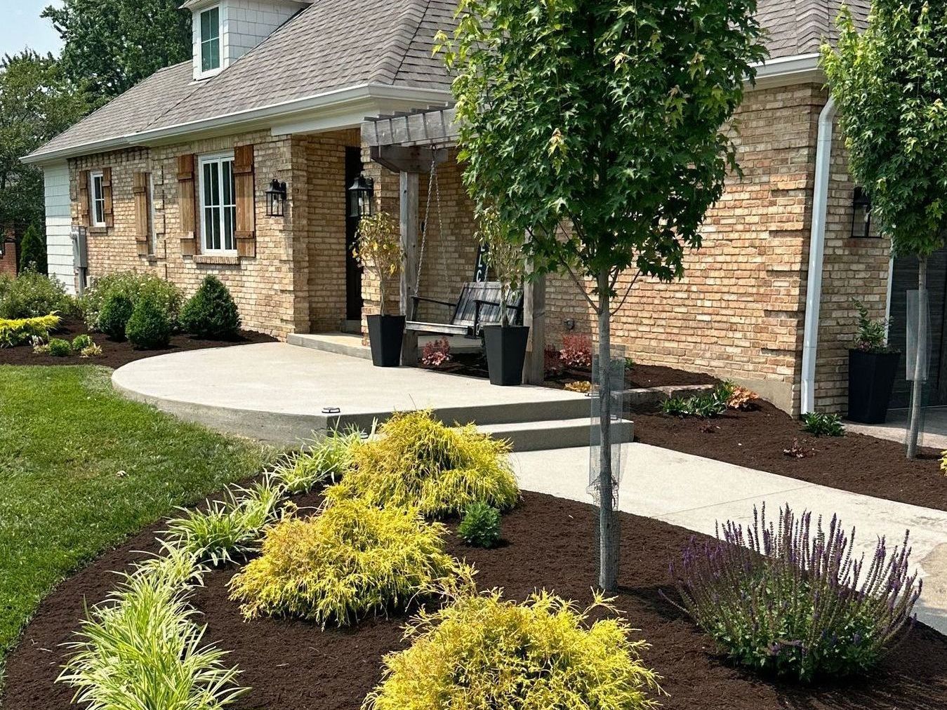 A house with a lot of landscaping in front of it.