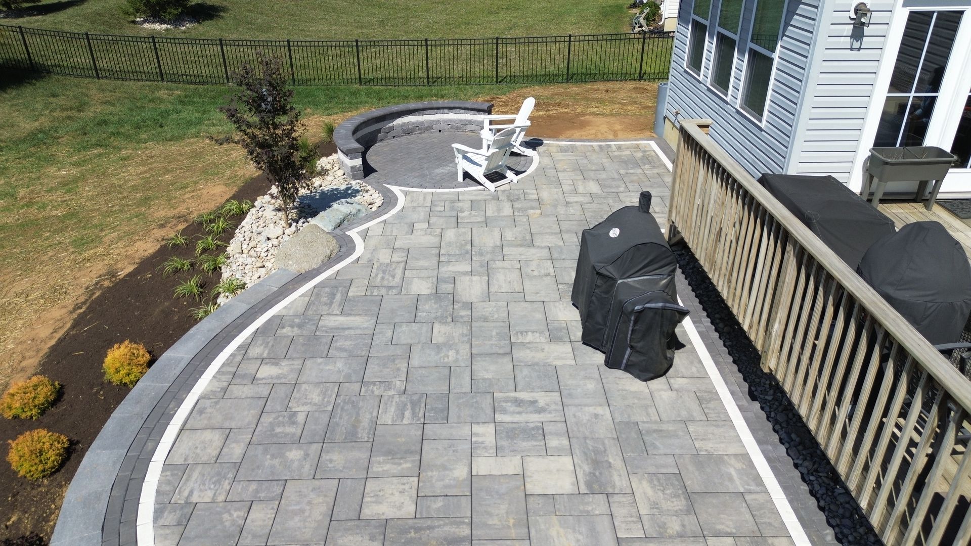 An aerial view of a patio with a grill and chairs.