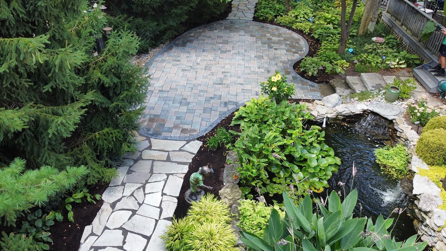 An aerial view of a house with a patio and a fire pit.