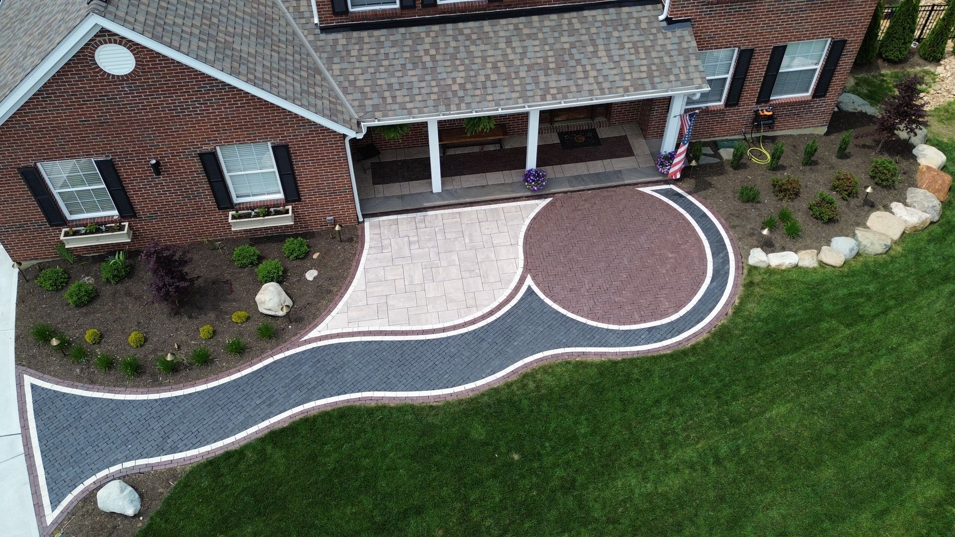 A brick house with a patio in front of it.