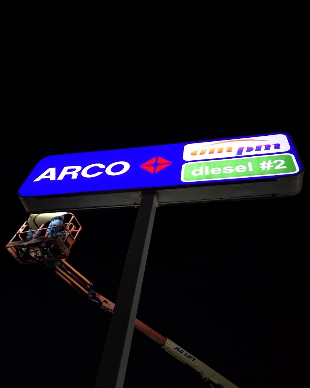 ARCO gas station sign at night with diesel #2 prices lit against a dark sky