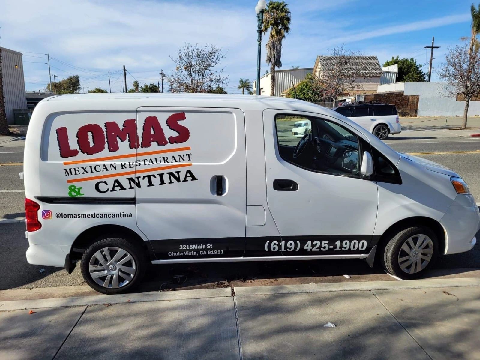 White Lomas Mexican Restaurant & Cantina delivery van parked on a street, with logo and phone number on side