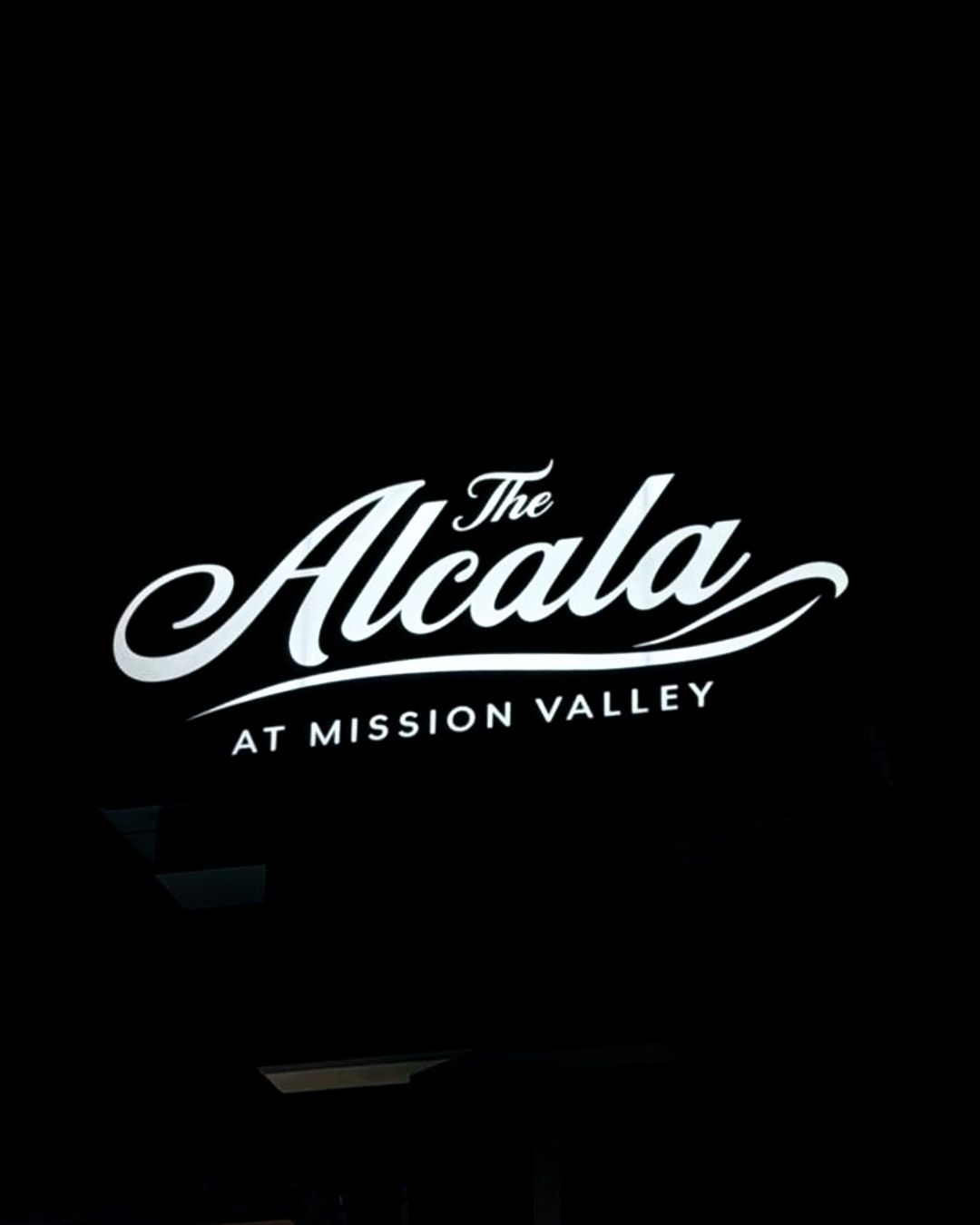 White The Alcala at Mission Valley logo on a black background
