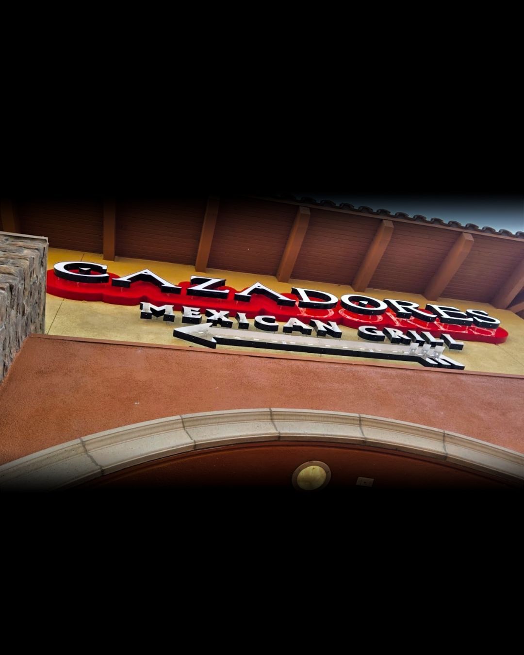 Caldwell’s restaurant sign on a red stucco building under a tiled roof.