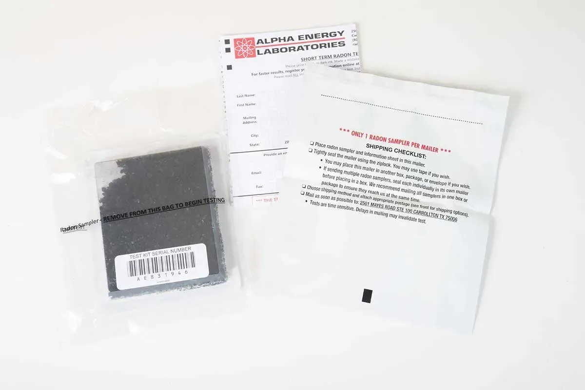 Plastic package with a small gray item and instruction sheet on a white background