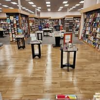 A bookstore filled with lots of books and tables.