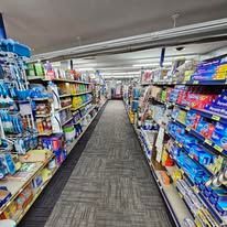 A long aisle in a grocery store filled with lots of products.