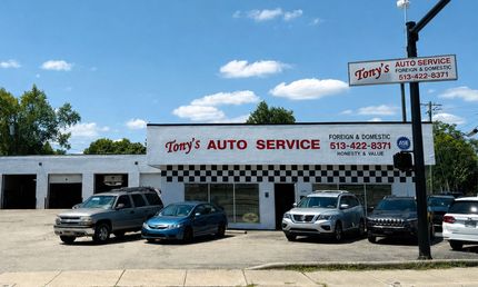 Tony’s Auto Service storefront with parked cars under a sunny blue sky