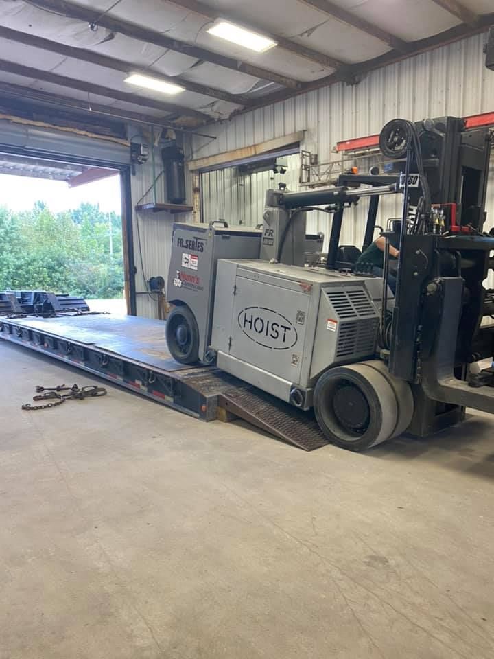 A forklift is sitting on a ramp in a garage.
