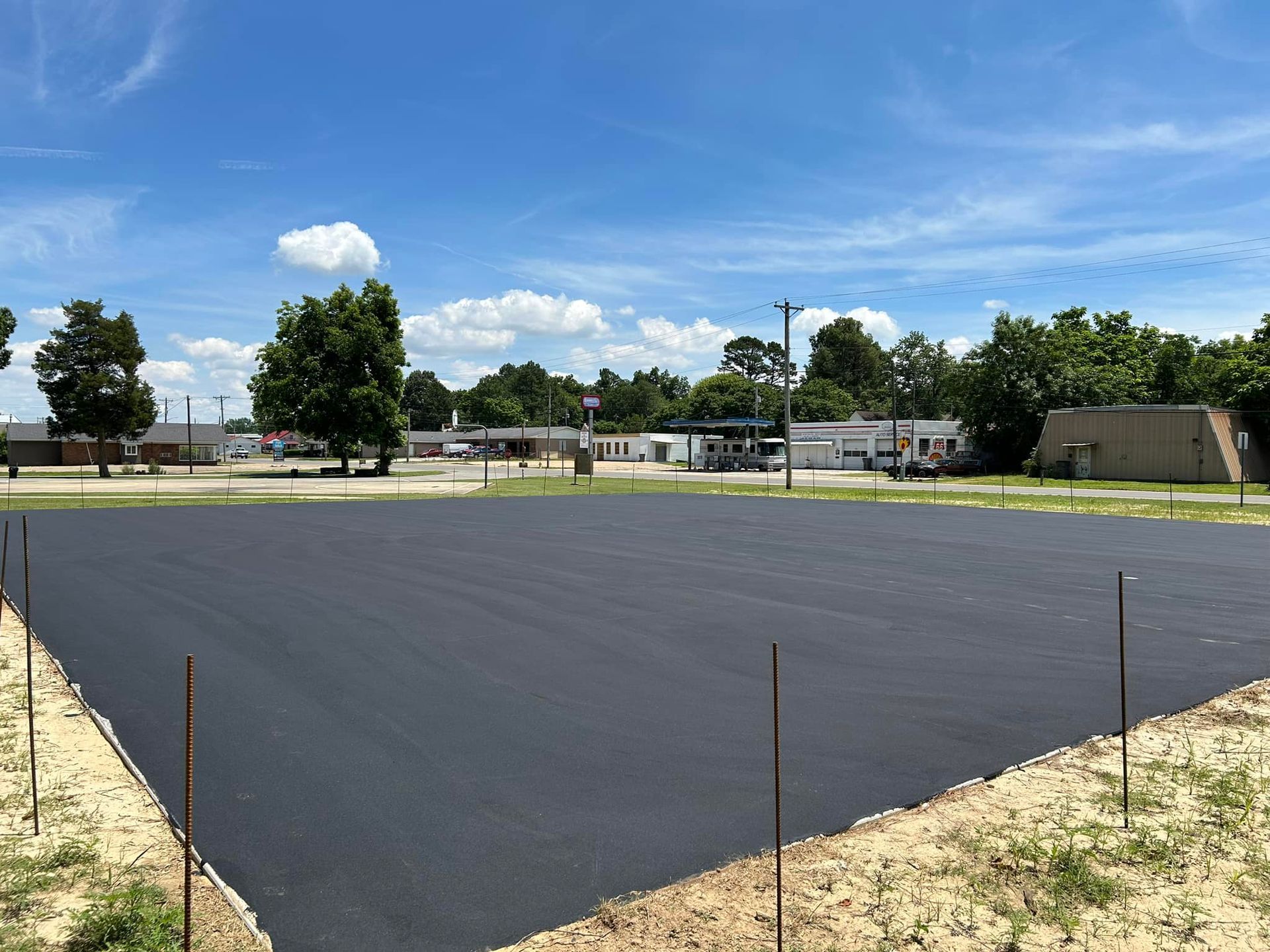 A basketball court is being built in the middle of a field.
