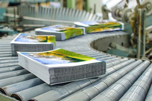 Stacks of packaged goods moving on a conveyor belt in a factory conveyor system