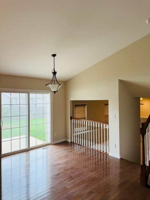 Basement interior: black ceiling beams, concrete floor, brick walls, and two ladders.