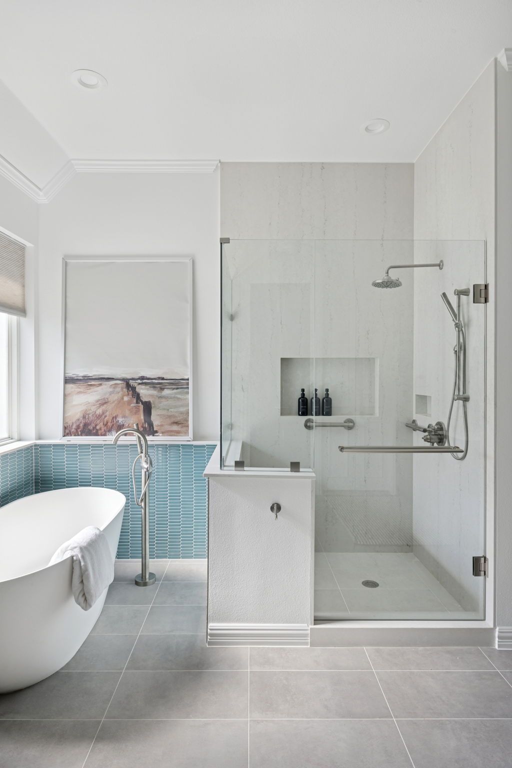 Modern bathroom with a walk-in shower, freestanding tub, and blue tiled accent wall