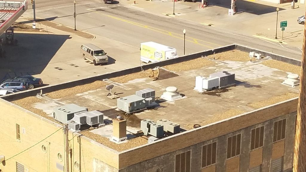 An aerial view of the roof of a building in a city