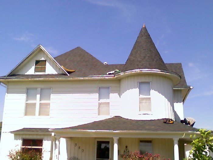 A white house with a cone shaped roof