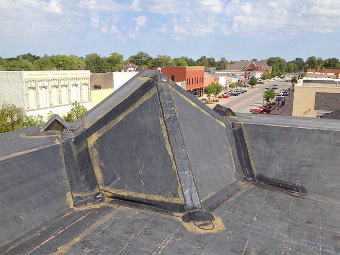 A rooftop view of a city with a pyramid shaped roof