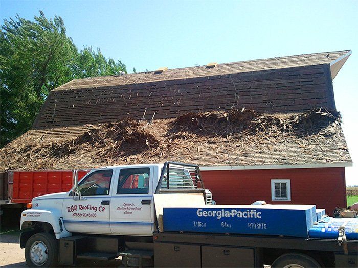 A georgia pacific truck is parked in front of a red barn