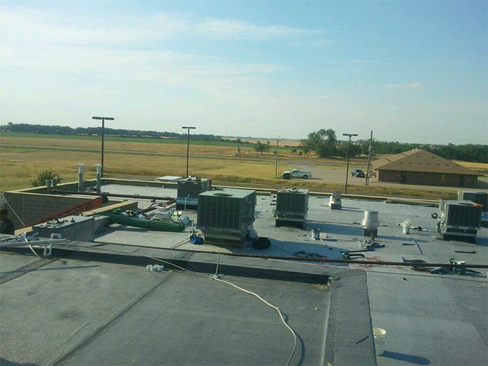 A rooftop with a lot of air conditioners on it