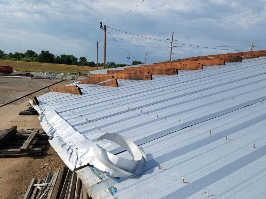 A metal roof with a hole in the middle of it.