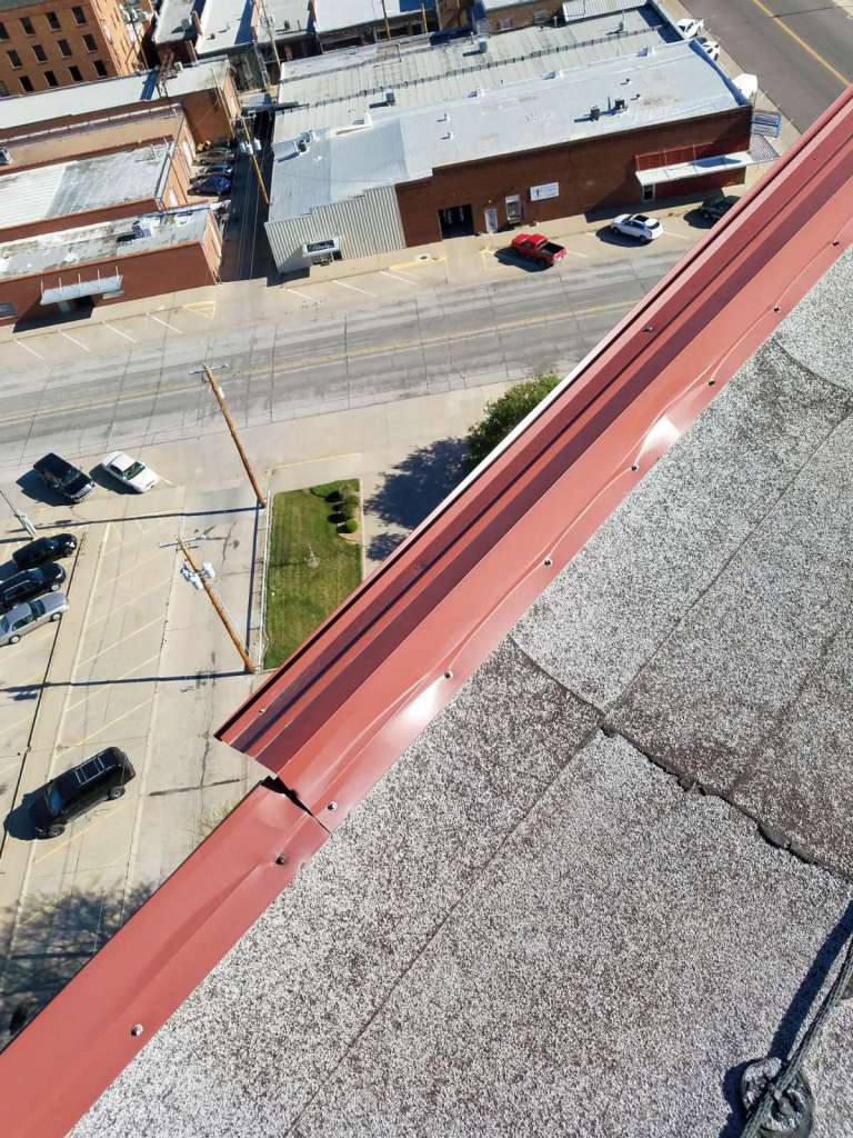 An aerial view of a roof with a red gutter