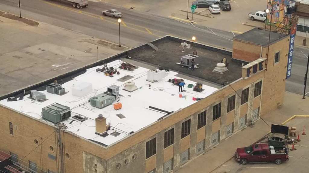 An aerial view of a building with a red truck parked in front of it.