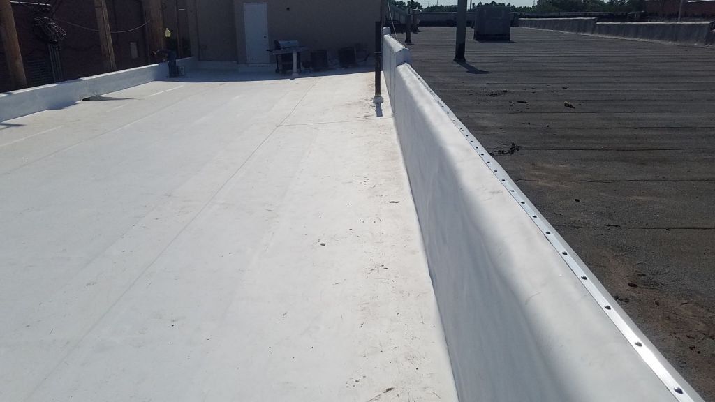 A white roof with a black roof in the background.