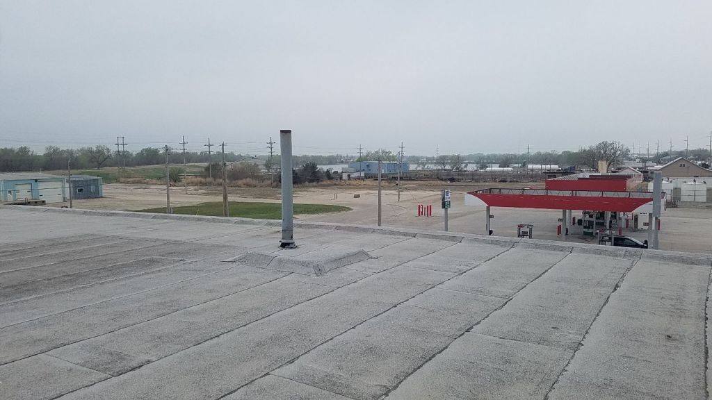 A rooftop view of a gas station on a cloudy day