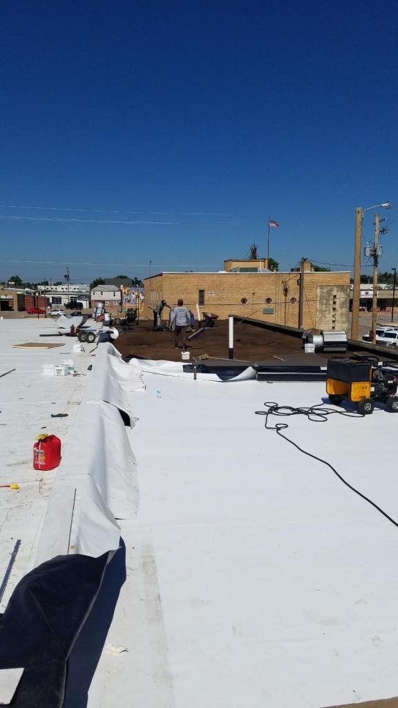 A white roof is being installed on top of a building.