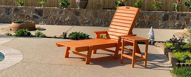 wooden lounge chair on a decorative spray deck