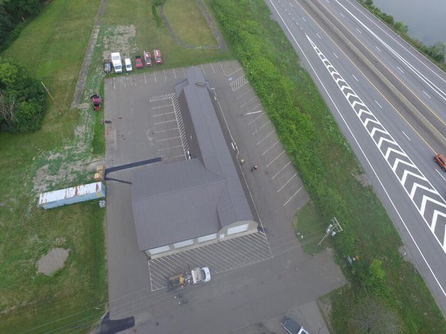 An aerial view of a parking lot next to a highway.