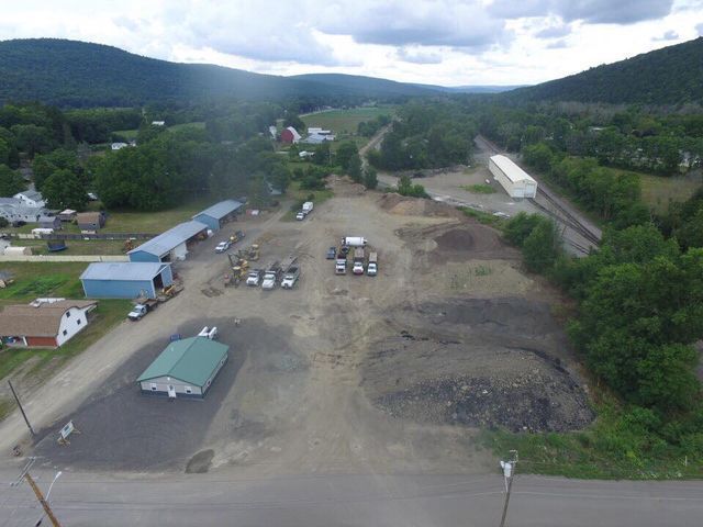 An aerial view of a small town with mountains in the background