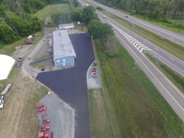 An aerial view of a building next to a highway.