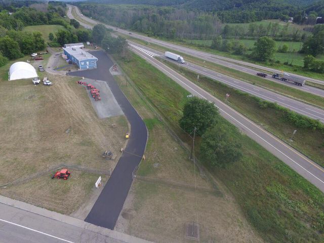An aerial view of a highway and a building.