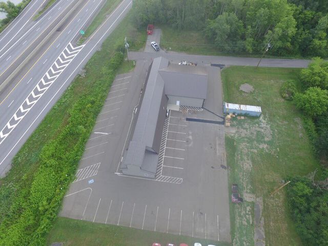 An aerial view of a parking lot next to a highway.