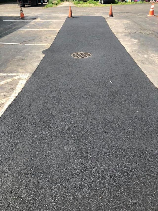 There is a manhole cover in the middle of the road.