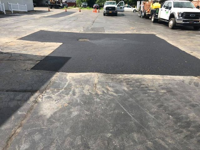 A lot of trucks are parked on the side of the road