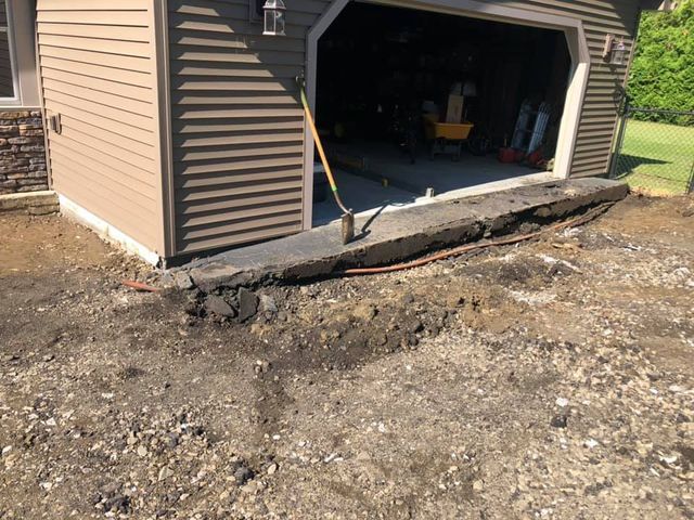 A garage with a shovel in front of it
