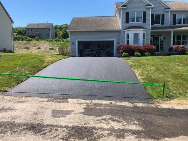 A driveway that has been paved in front of a house.