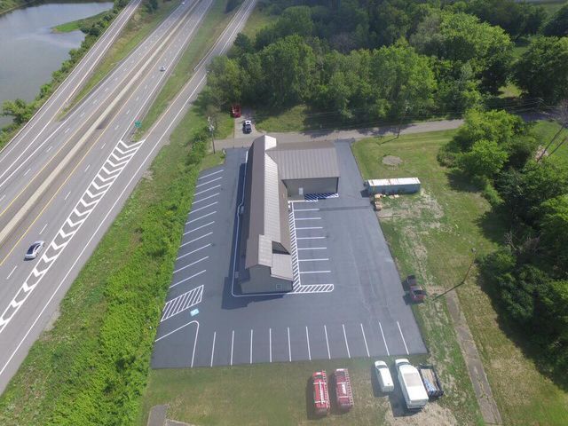 An aerial view of a parking lot next to a highway.