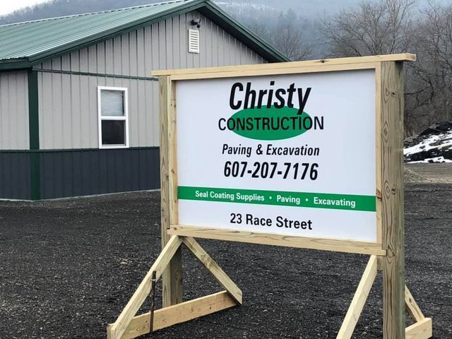 A sign for christy construction is in front of a building