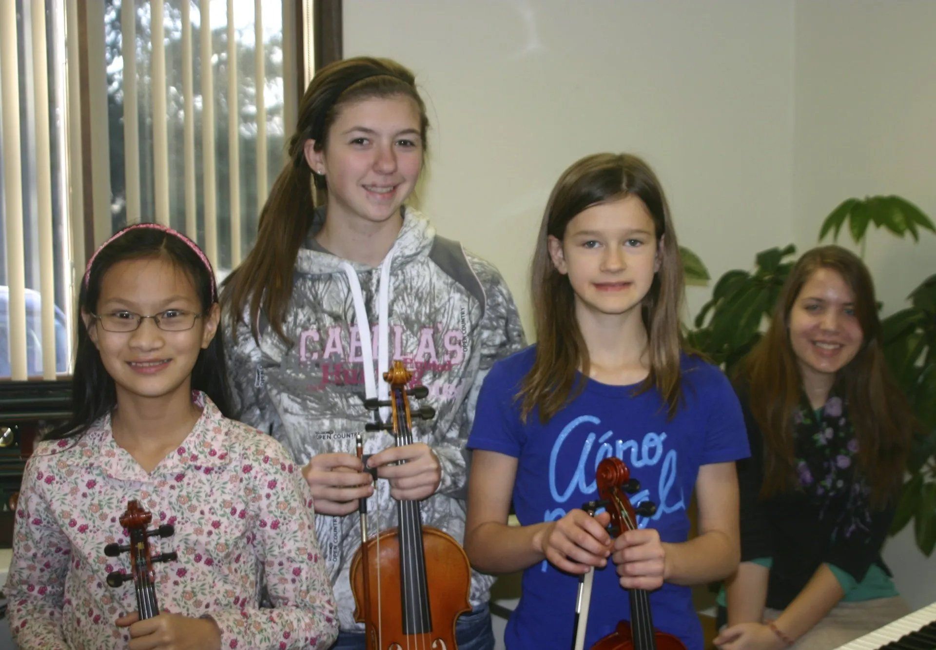 Girls holding violins